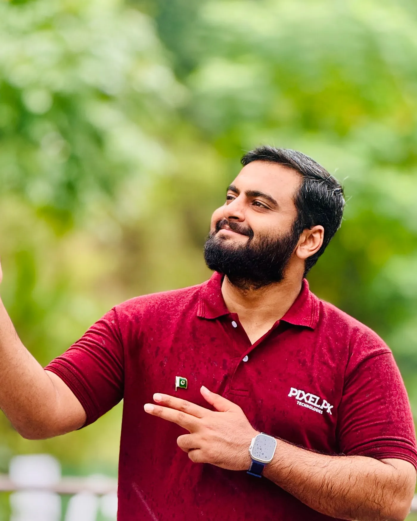 Syed Anas in a Pixelpk Technologies shirt, outdoors.